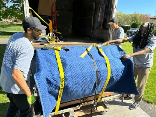 a-crew-of-movers-putting-a-grand-piano-in-a-truck.